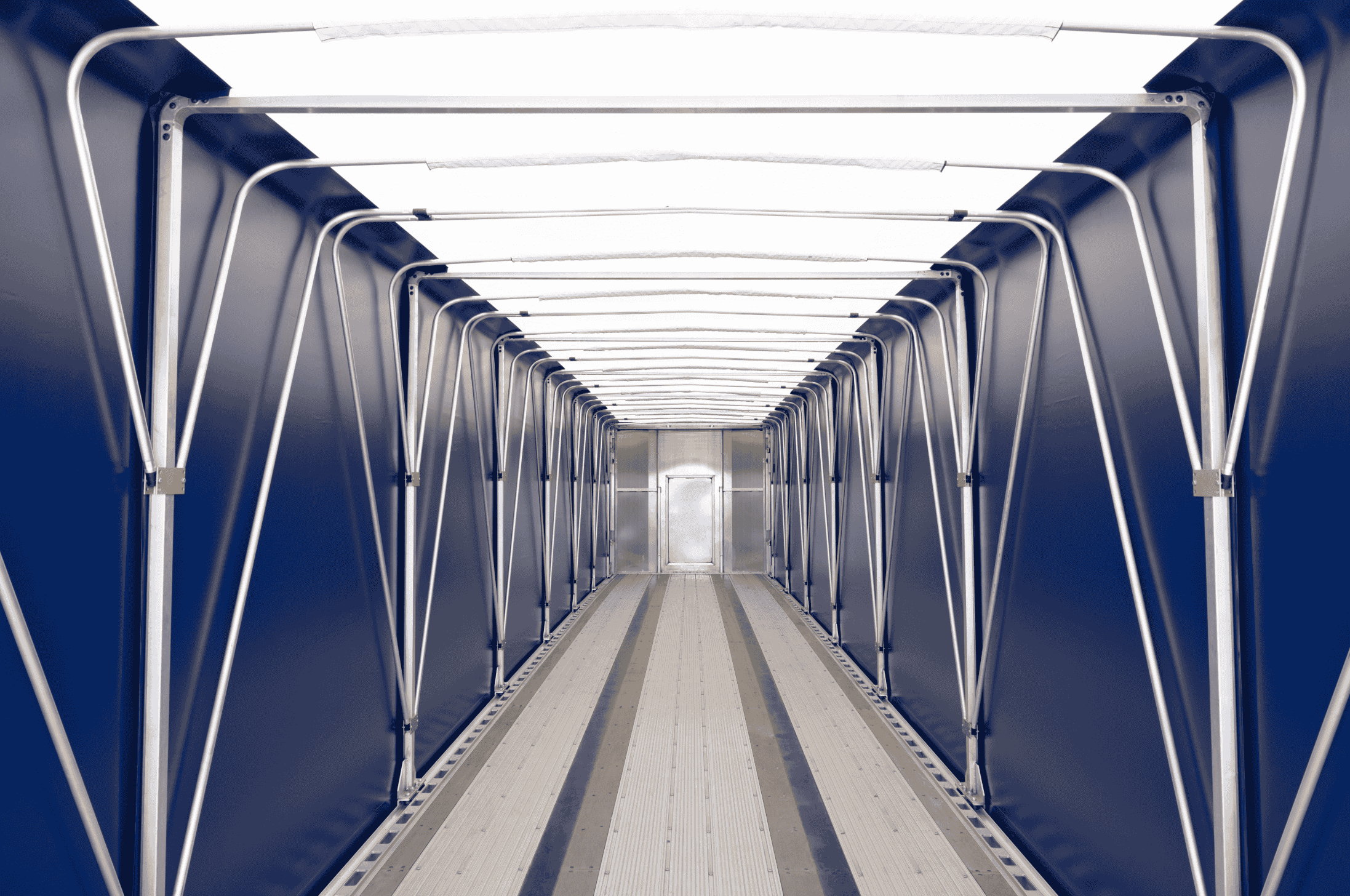 Interior view of a Hyundai Translead Latitude flatbed trailer with a blue retractable tarp system, highlighting its internal structure and advanced trailer technology for cargo protection.